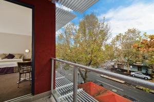 a room with a balcony with a view of a street at Carlton Lygon Lodge - Close to Melbourne Uni in Melbourne