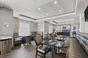 a waiting room with tables and chairs at Holiday Inn Express & Suites Gonzales by IHG in Gonzales