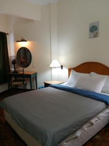 a bedroom with a bed and a table and a chair at Seri Bulan Condo in Port Dickson +104 photos