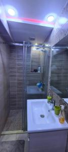 a bathroom with a white sink and a shower at Le Familial in Riffiene +13 photos
