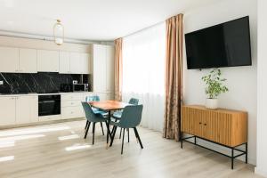 a kitchen and dining room with a table and chairs at Thirty Six Apartment in Bistriţa