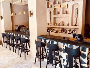 a bar with a row of stools in a restaurant at TheSoulHouseBali in Canggu +40 photos
