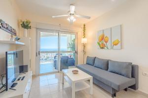 a living room with a couch and a table at Trebol House, Edificio Cañadas, Golf del Sur in San Miguel de Abona