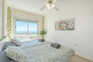 a bedroom with two beds and a window at Trebol House, Edificio Cañadas, Golf del Sur in San Miguel de Abona