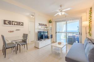 a living room with a couch and a table and a tv at Trebol House, Edificio Cañadas, Golf del Sur in San Miguel de Abona