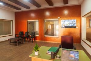 a waiting room with chairs and a table at Sancta Maria Airport Hotel in Cochin