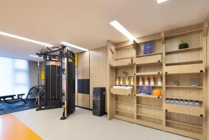 a room with a gym with wooden shelves at Home2 Suites By Hilton Wuxi Huishan in Wuxi