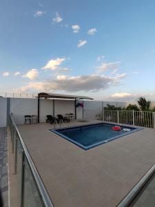 a swimming pool on the roof of a house at Alharf Rest in Sayq +11 photos