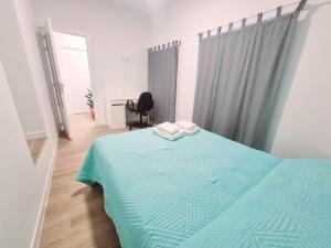 a bedroom with a bed with a blue comforter at Vivienda El Viajero in Valverde
