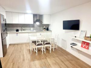 a kitchen and dining room with a table and chairs at Vivienda El Viajero in Valverde +12 photos