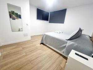 a bedroom with a bed and paintings on the wall at Vivienda El Viajero in Valverde