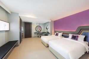 Voodi või voodid majutusasutuse Hotel Selene Chiang Rai toas