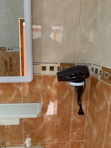 a phone is hanging on the wall of a bathroom at Taghazout waves 2 in Taghazout +16 photos