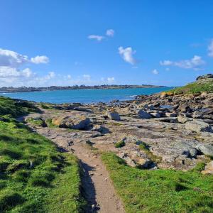 a path on the shore of a rocky beach at Gîte breton au bord du GR34 in Landunvez