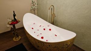 a bath tub with red hearts on it in a bathroom at VICTORIAN HOUSE in Sibiu +65 photos