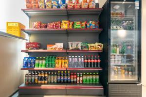 a refrigerator filled with lots of different types of drinks at 际庭青年旅舍-马当路地铁站店 in Shanghai