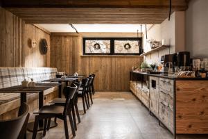 a restaurant with wooden walls and tables and chairs at Owce Dwie in Zakopane