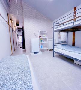 a room with two bunk beds and a refrigerator at 2 type room, Akira&chacha guest home杉並区世田谷direct to shinjuku for 13 min 上北沢3分 近涉谷新宿Suitable for three or more people in Tokyo +48 photos