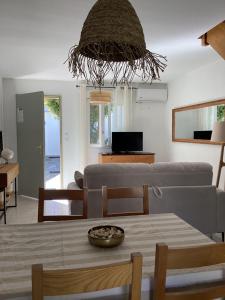 a living room with a couch and a table at La BénéCIOLA, vue Mer, Box Fibre SFR, High Speed Internet in Cervione