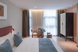 Postel nebo postele na pokoji v ubytování 重庆文里苗品茶艺术酒店Chongqing Jiangbei Airport Creative Park Store