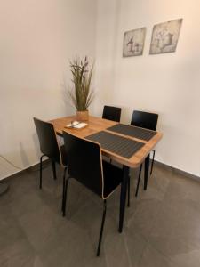 a dining room table with four chairs around it at Coralia's House in Nea Moudania +15 photos