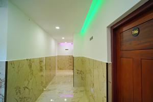 a hallway with a door and a marble floor at GH Grand Park in Angamaly +62 photos