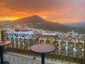 a view of a city from a balcony at sunset at Hotel Golden Star in Taounate