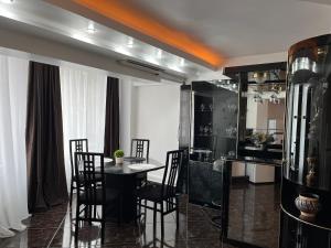a dining room with a table and chairs at BlueBee Apartment in Orăştie