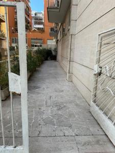 a stone walkway next to a building with a bench at Gianicolo House in Rome +10 photos