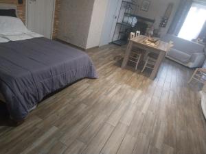 a bedroom with a bed and a wooden floor at La Piemontesina in Nizza Monferrato