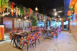 a dining room with tables and chairs and lights at Hotel Hari Piorko - New Delhi Railway Station in New Delhi +79 photos