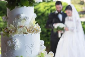 a bride and groom standing next to a wedding cake at Hotel Cala di Volpe, a Luxury Collection Hotel, Costa Smeralda in Porto Cervo +148 photos