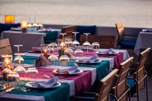 a group of tables with plates and wine glasses at Hotel Villa Mahal in Kalkan +37 photos