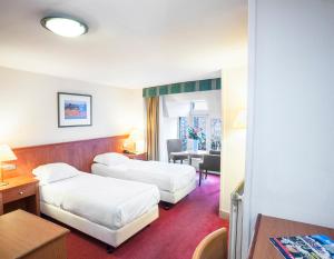 Postel nebo postele na pokoji v ubytování Delta Hotel City Center