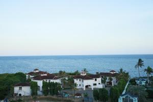 a group of houses in front of the ocean at AMP HOME STAY NYALI PRIVATE ROOM WITH POOL in Mombasa