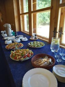 a blue table with plates of food on it at Laugu Guesthouse in Kuusalu