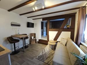 ein Wohnzimmer mit einer Couch und einem Tisch in der Unterkunft Gemütliche Ferienwohnung im Westerwald - "Ferienwohnung Braun" in Weitefeld