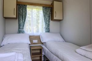 En eller flere senge i et værelse på Tehidy Holiday Park