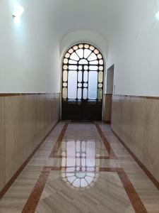 an empty hallway with a door and a window at GTapartment in Rome +17 photos