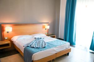 Letto o letti in una camera di Hotel Scoglio Degli Achei