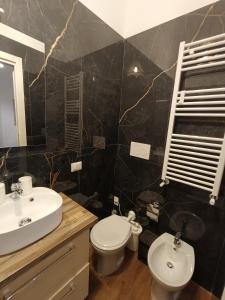 a bathroom with a white toilet and a sink at GTapartment in Rome