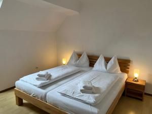 a bedroom with a bed with two towels on it at Haus Peter in Murau