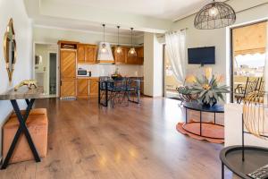 a living room with a kitchen and a dining room at Chania dream apartment in Chania
