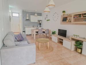 a living room with a couch and a table at Casa GABRIEL 1 Bedroom Wifi Free Pool in Costa Del Silencio