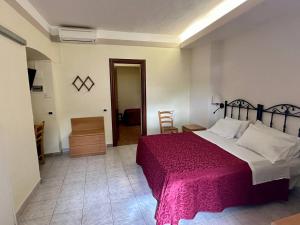 A bed or beds in a room at Locanda Fosca Umbra