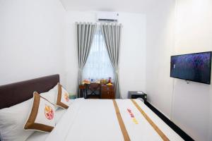 Postel nebo postele na pokoji v ubytování The Rice 131 Bui Vien Hotel