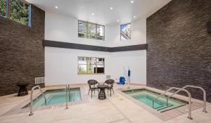a swimming pool with a table and chairs in a building at Palisades Tahoe Lodge Rentals Premium Studio #252 in Olympic Valley +12 photos