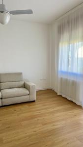 a living room with a couch and a window at Appartamento Vittoria in Rovigo