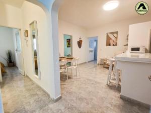 a living room with a kitchen and a dining room at VolKKanrentals Casa Pilar in Famara +12 photos