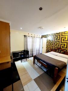 Postel nebo postele na pokoji v ubytování Nairobi Glory Palace Hotel